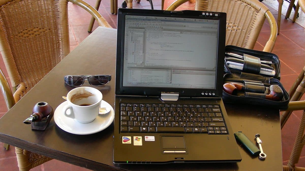 A mobile workspace with a laptop and coffee